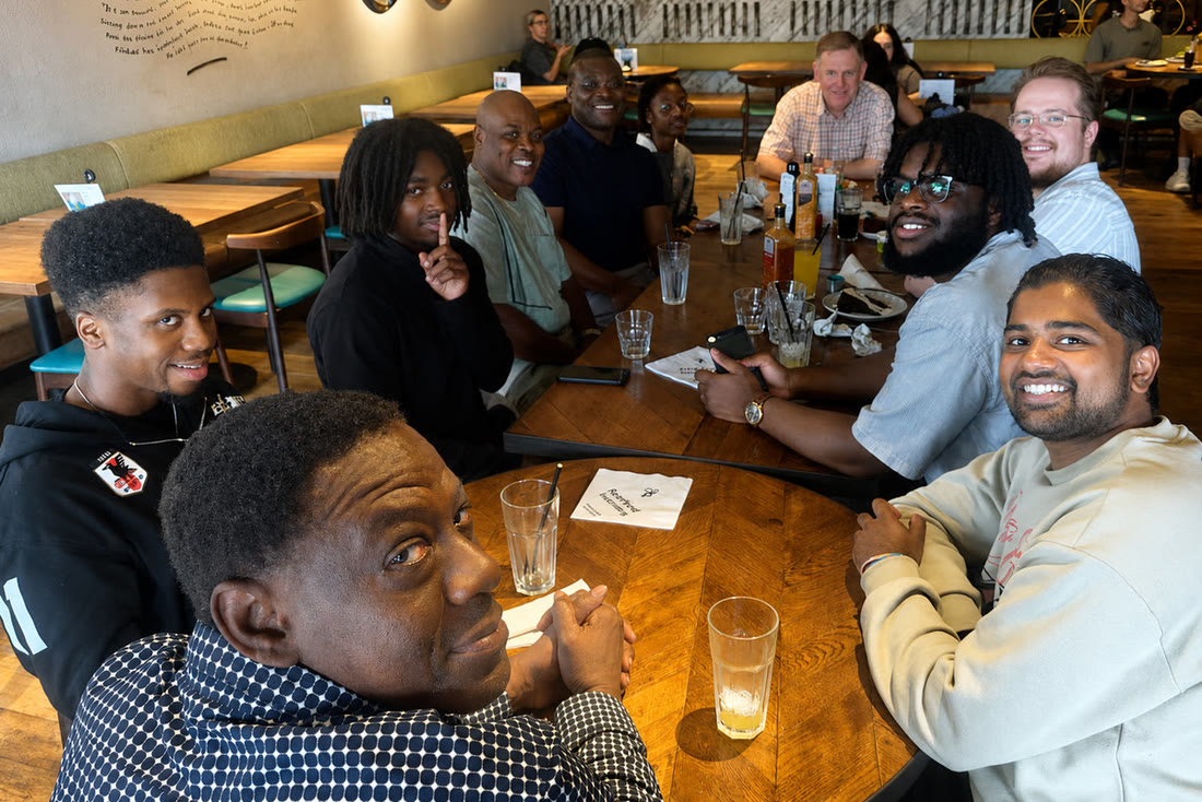 A group from the church sharing a meal together around a table